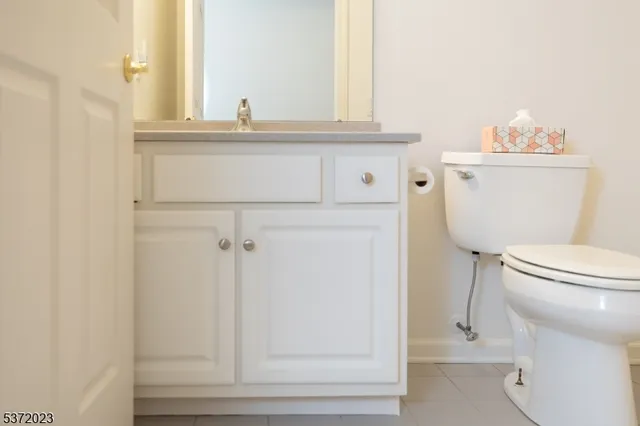 a bathroom with a toilet a sink and a window