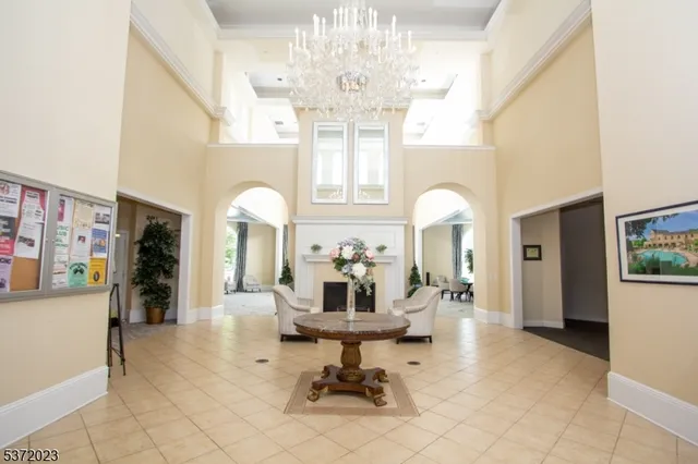 a living room with fireplace furniture and a chandelier