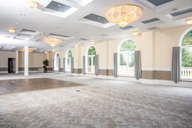 an empty room with windows and outdoor view