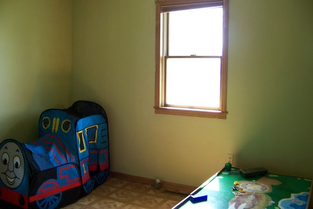 304 East Beech Street Chatsworth, IL 60921 - Photo 2 of 16 a bedroom with a bed and a window