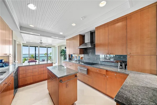 a kitchen with stainless steel appliances granite countertop sink stove and cabinets