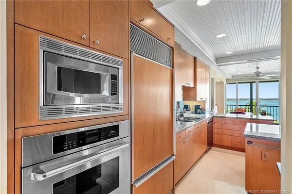 a kitchen with stainless steel appliances a stove sink and microwave