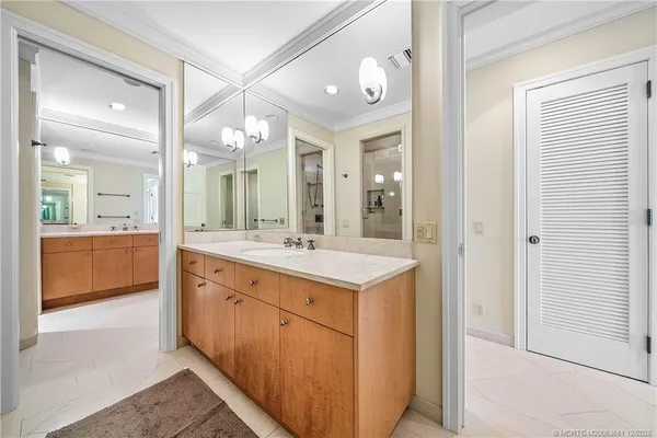 a bathroom with a sink vanity and a mirror