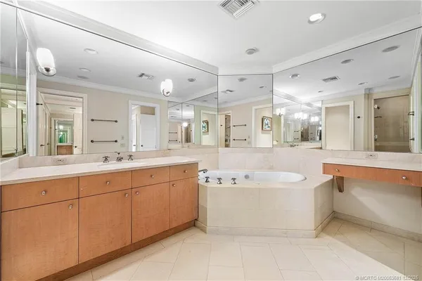 a spacious bathroom with a large tub shower and sink