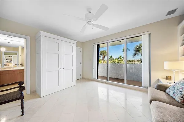 a living room with furniture and a ceiling fan