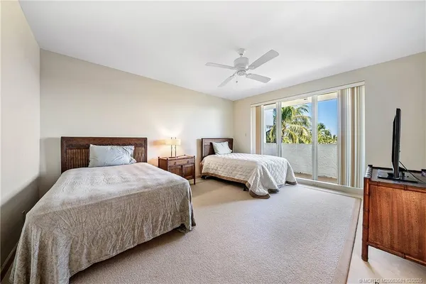 a bedroom with two beds and a flat screen tv