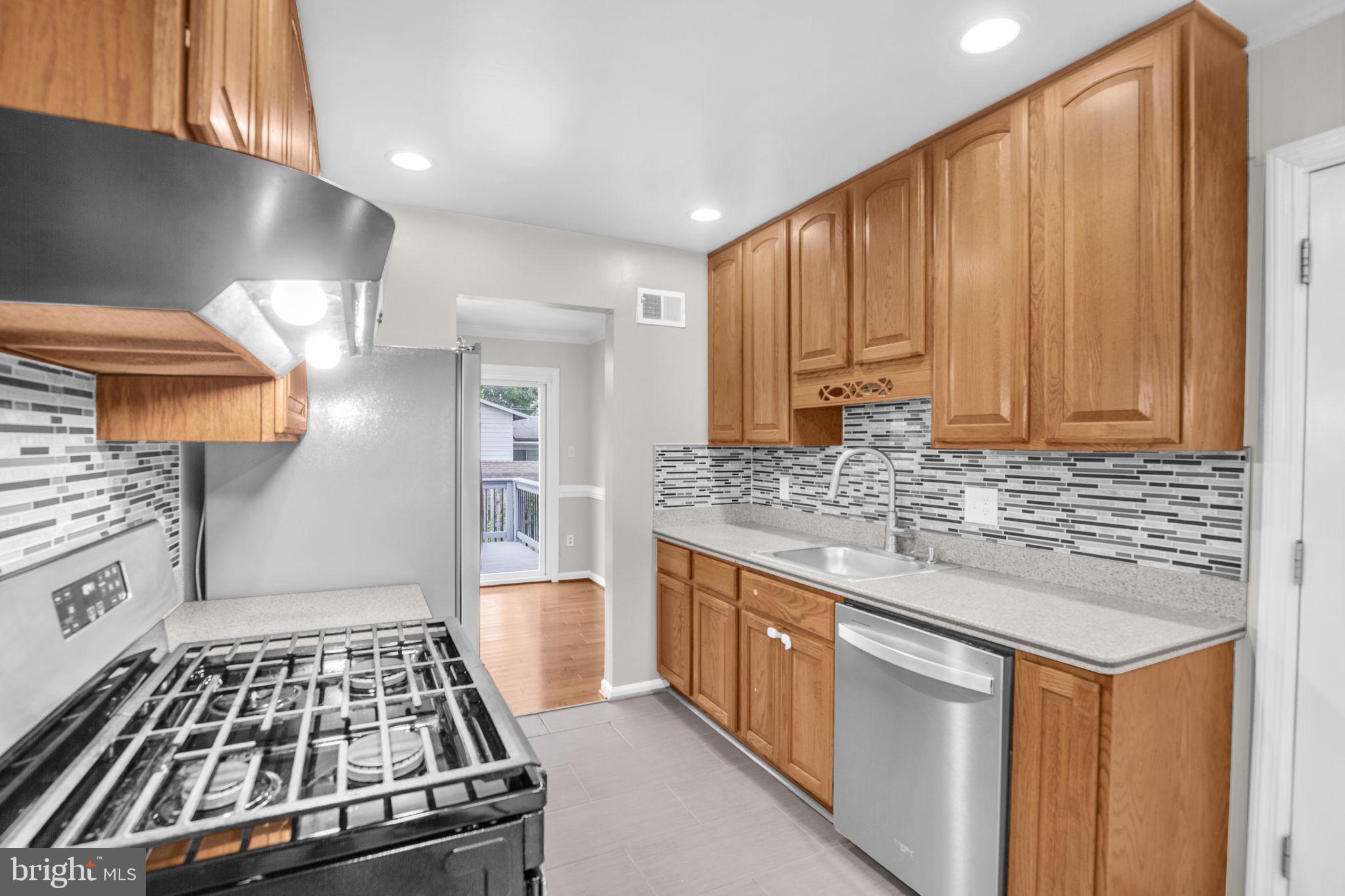 4403 Kinmount Road Lanham, MD 20706 - Photo 11 of 39 a kitchen with granite countertop a stove and a sink