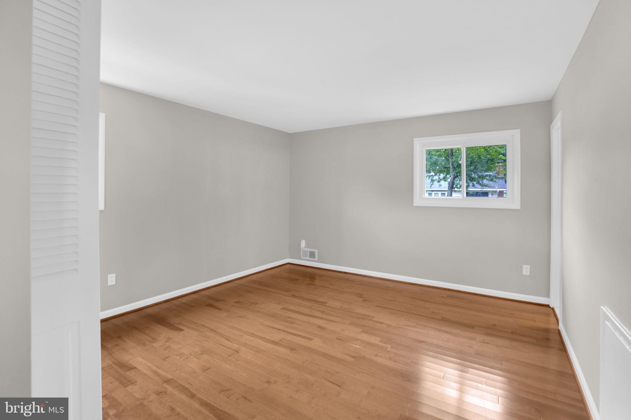 4403 Kinmount Road Lanham, MD 20706 - Photo 17 of 39 an empty room with wooden floor and window