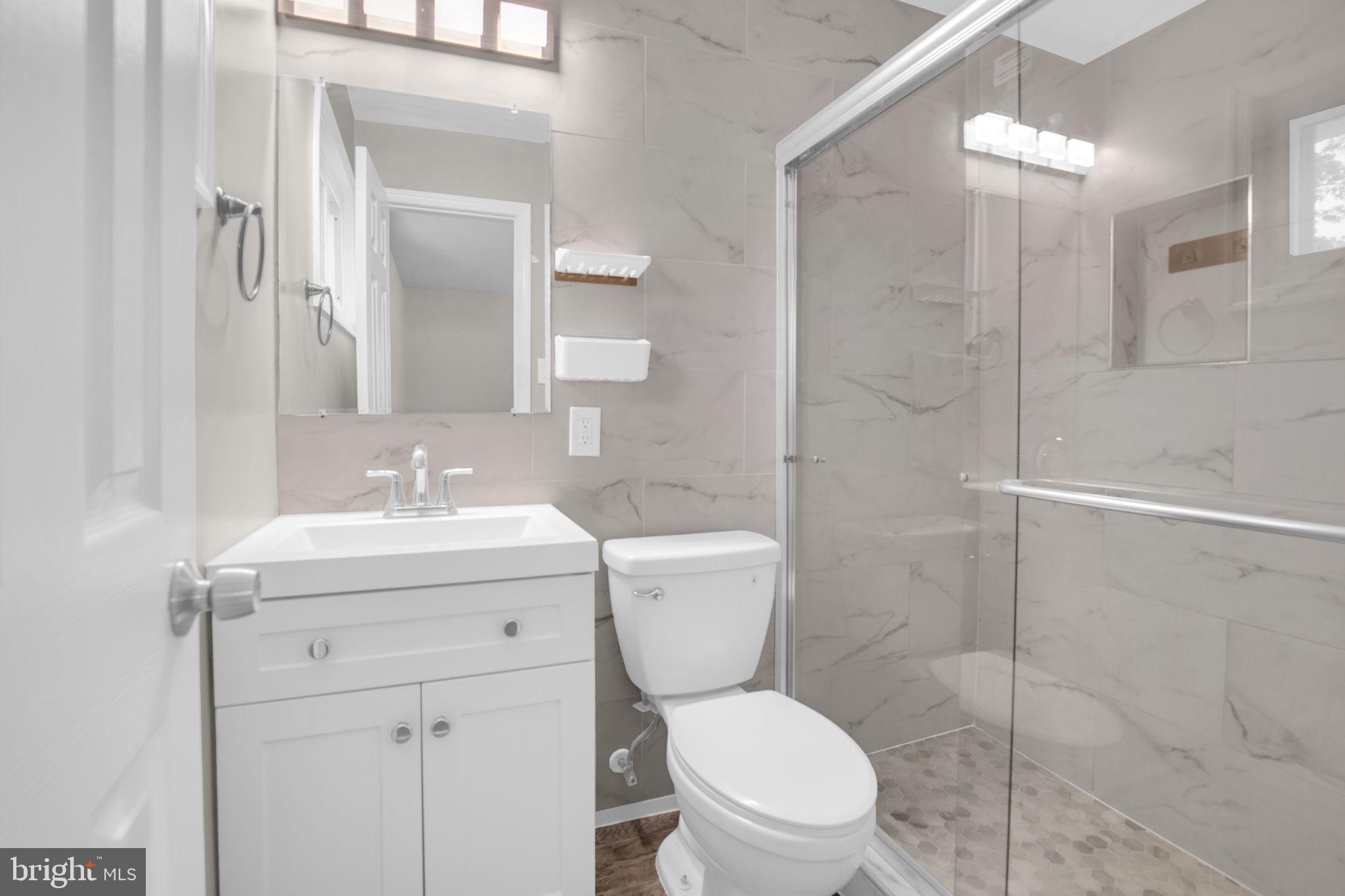 4403 Kinmount Road Lanham, MD 20706 - Photo 19 of 39 a bathroom with a sink toilet and shower
