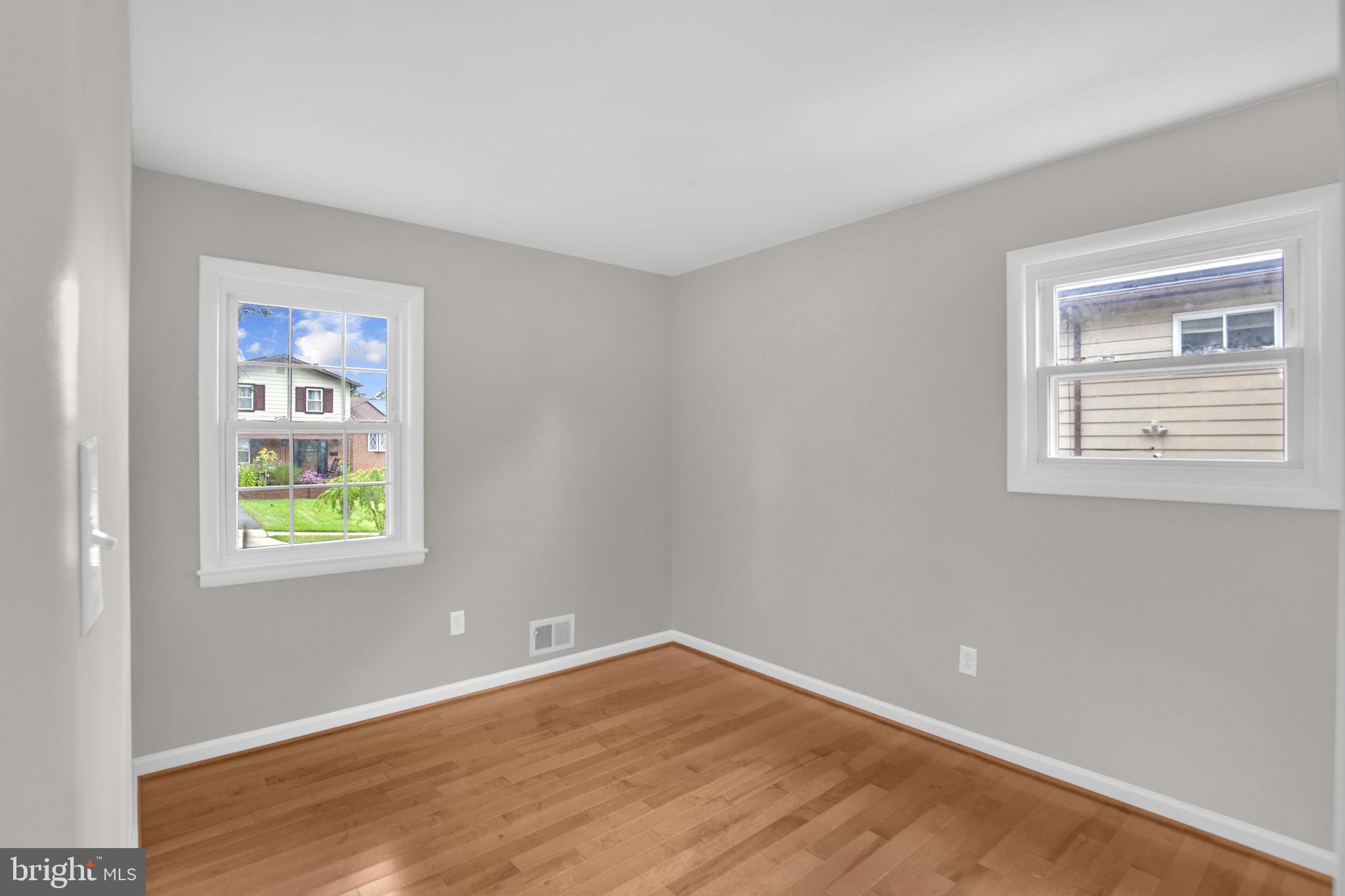 4403 Kinmount Road Lanham, MD 20706 - Photo 20 of 39 a view of an empty room with wooden floor and a window