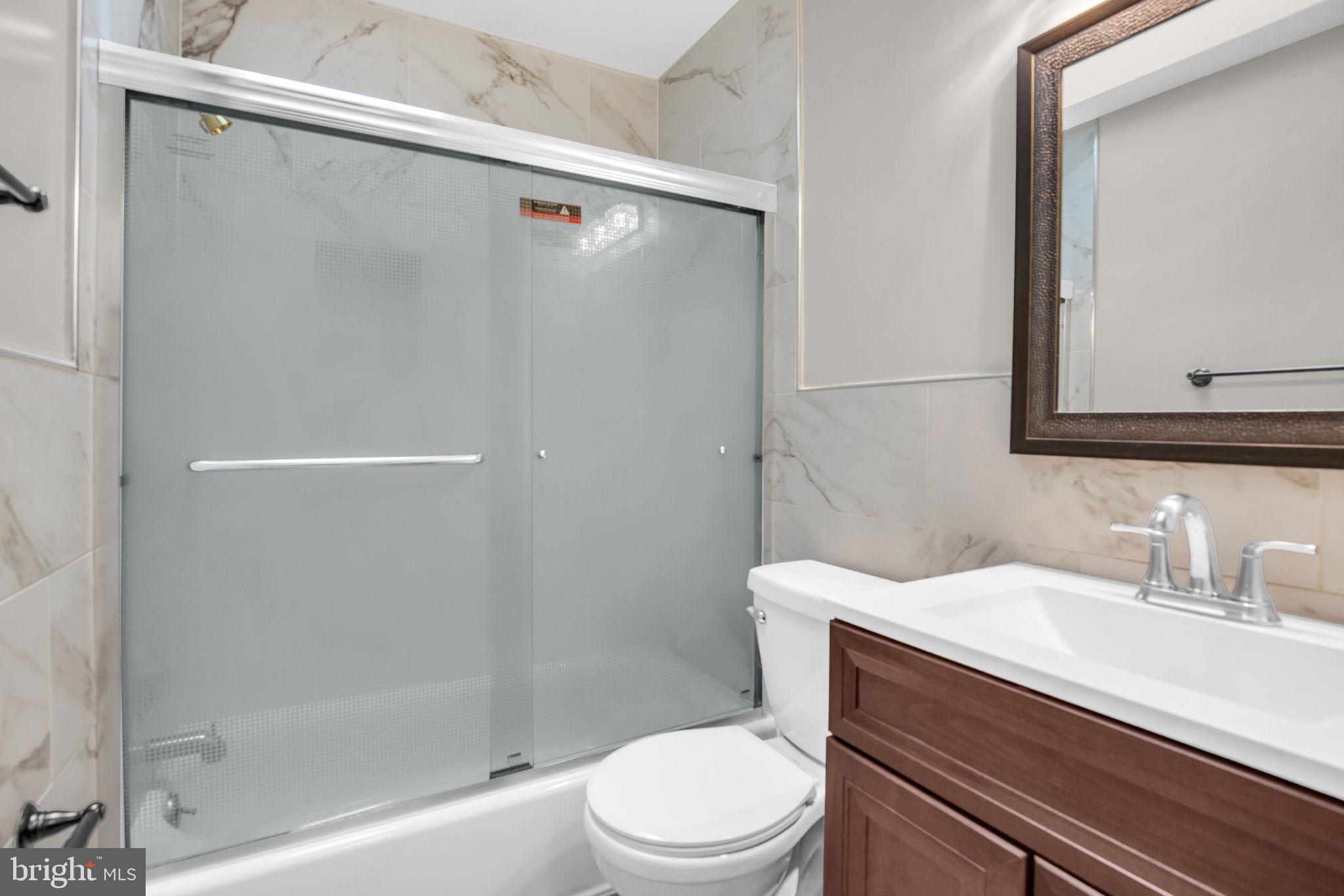 4403 Kinmount Road Lanham, MD 20706 - Photo 22 of 39 a bathroom with a sink a toilet and shower