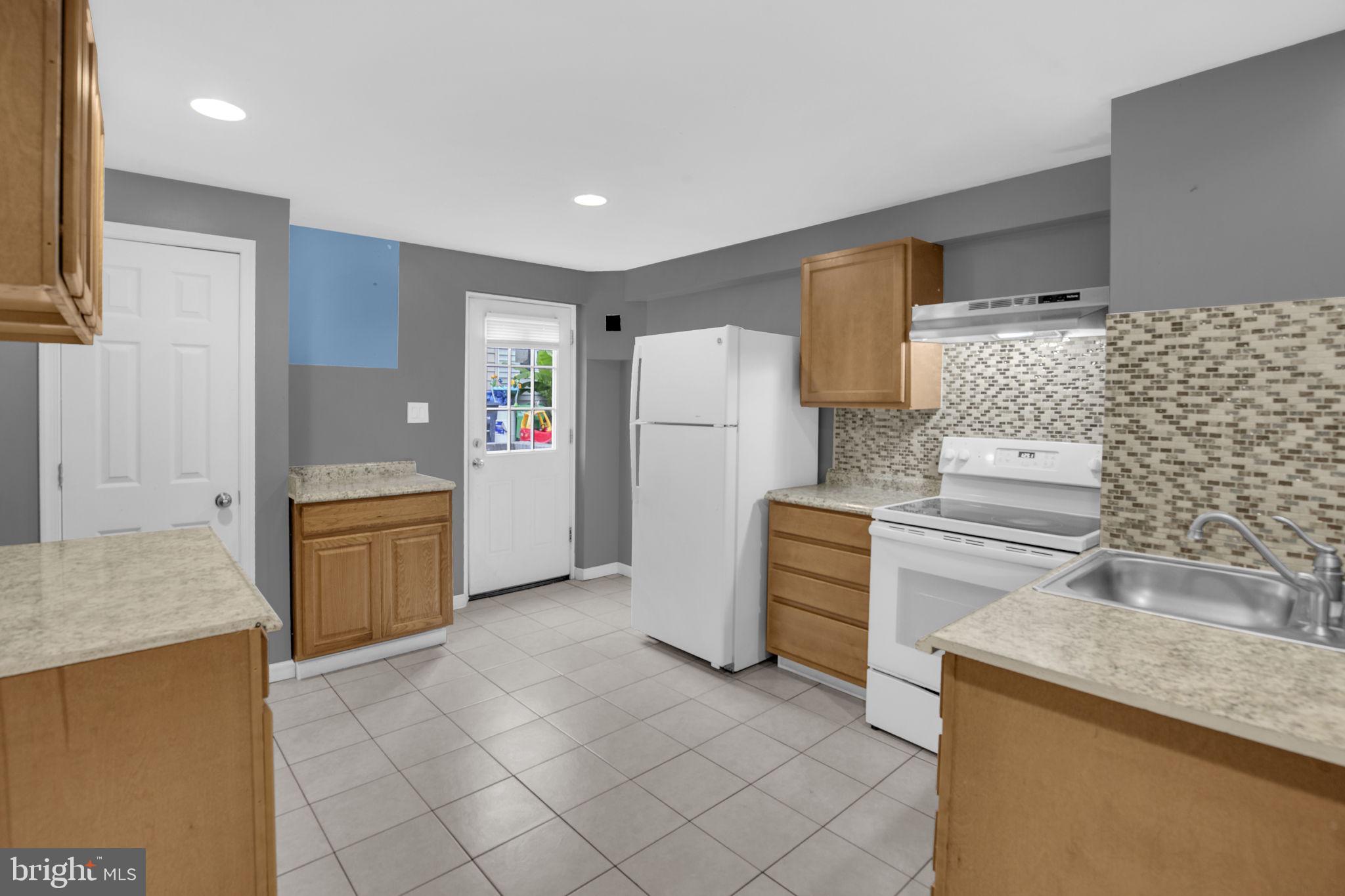 4403 Kinmount Road Lanham, MD 20706 - Photo 33 of 39 a kitchen with a refrigerator sink and stove