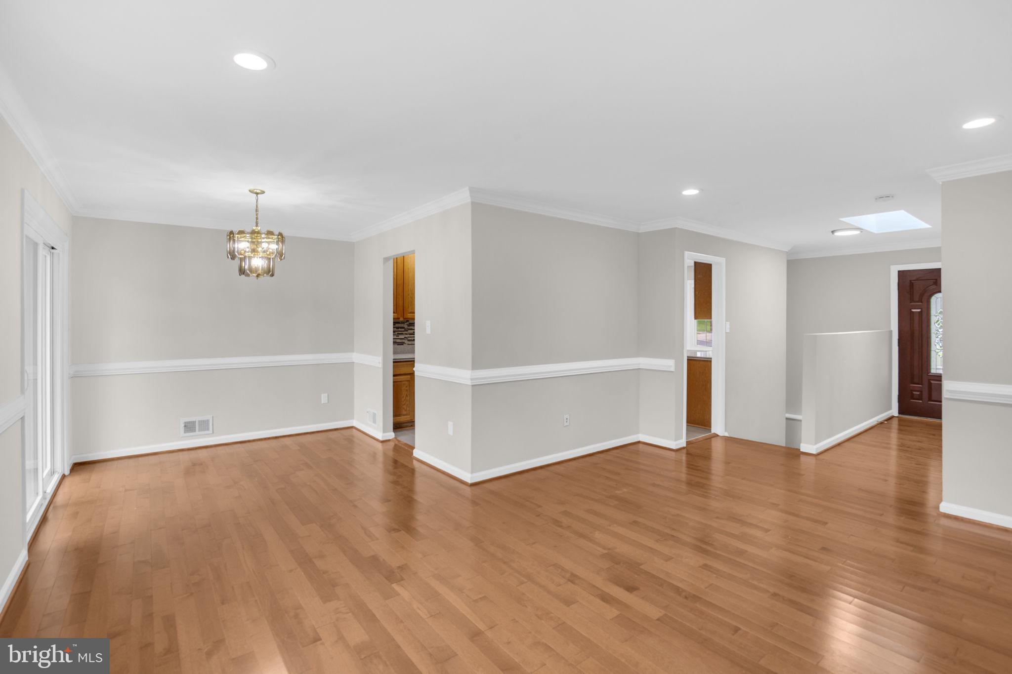 4403 Kinmount Road Lanham, MD 20706 - Photo 5 of 39 a view of an empty room with wooden floor kitchen view and a window