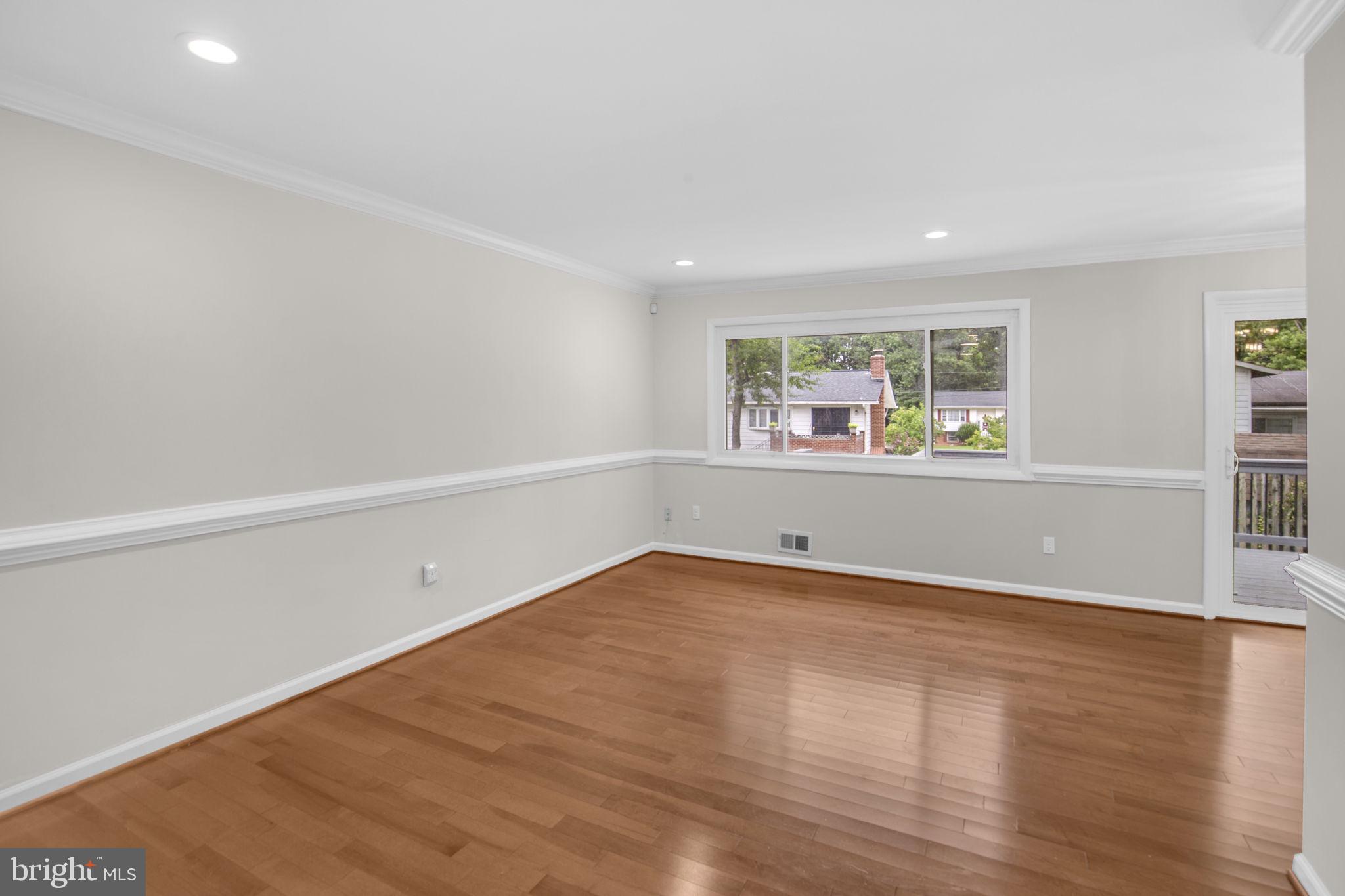 4403 Kinmount Road Lanham, MD 20706 - Photo 7 of 39 an empty room with wooden floor and windows