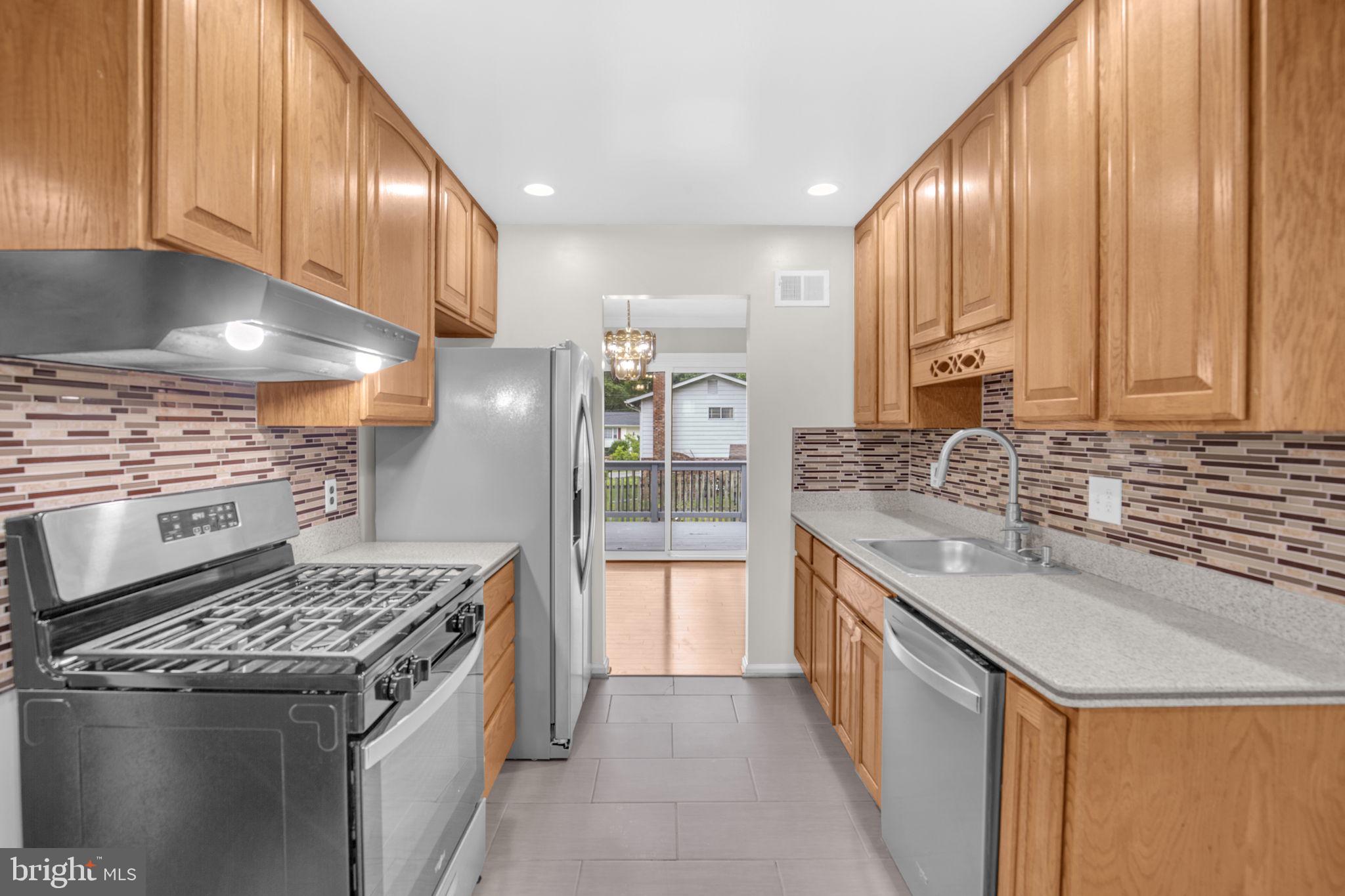 4403 Kinmount Road Lanham, MD 20706 - Photo 9 of 39 a kitchen with a sink stove top oven and cabinets
