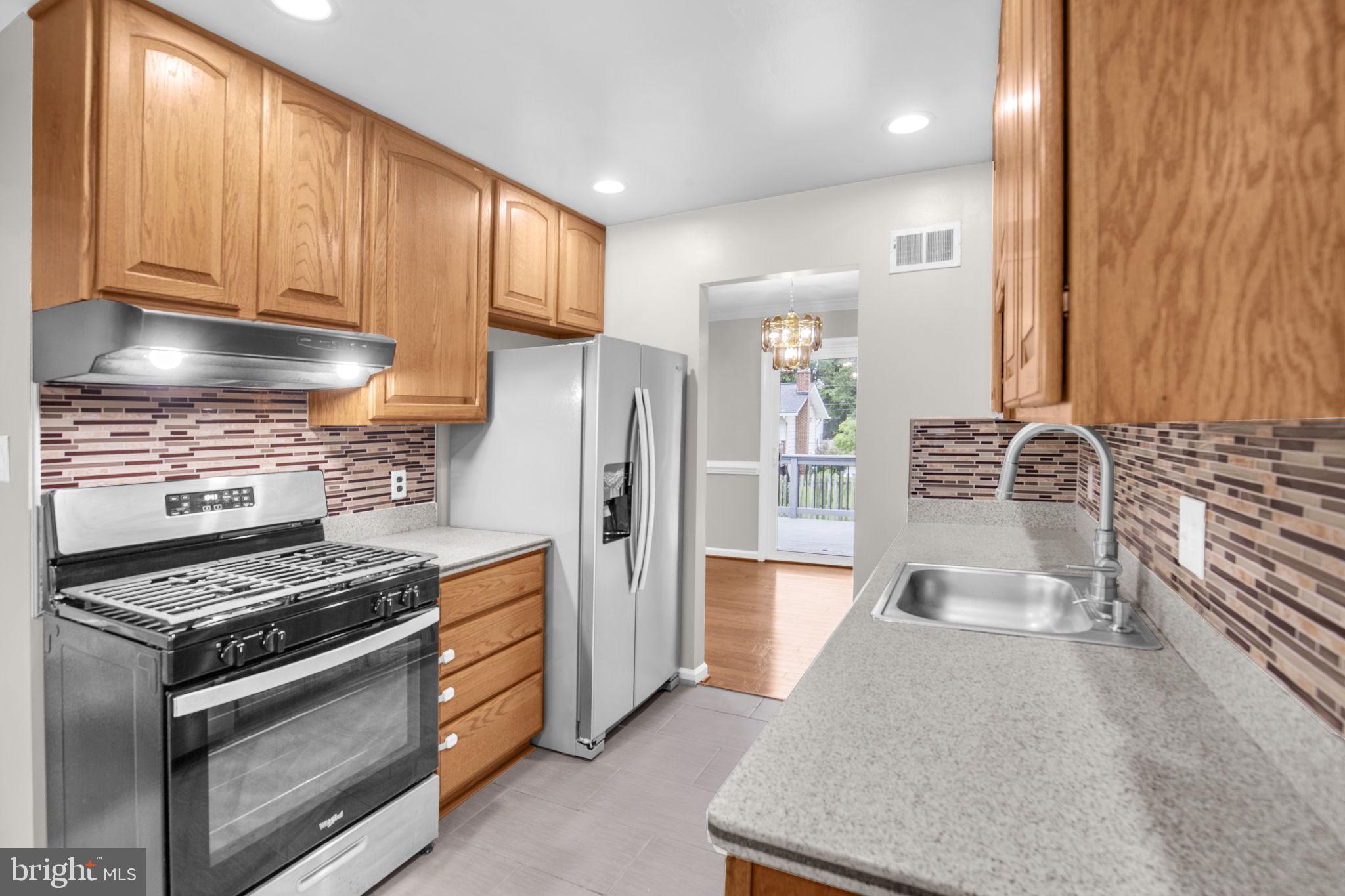 4403 Kinmount Road Lanham, MD 20706 - Photo 10 of 39 a kitchen with stainless steel appliances granite countertop a stove and a refrigerator