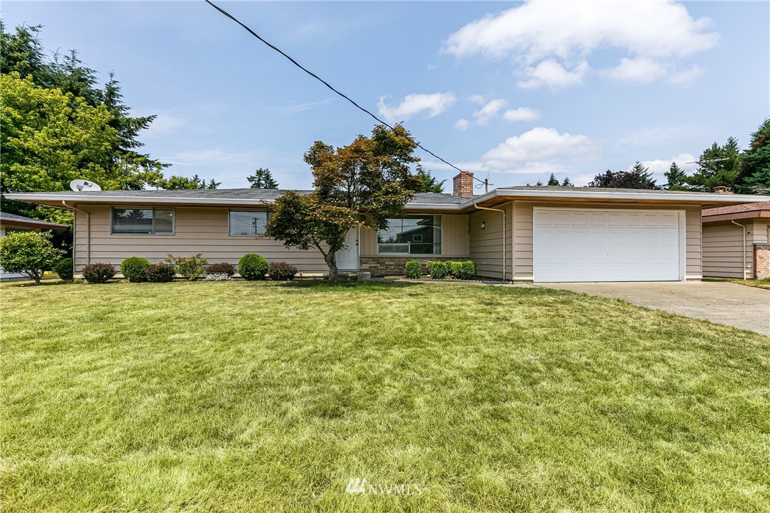 2608 Northeast 18th Street Renton, WA 98056 - Photo 1 of 20 a front view of house with yard and trees around