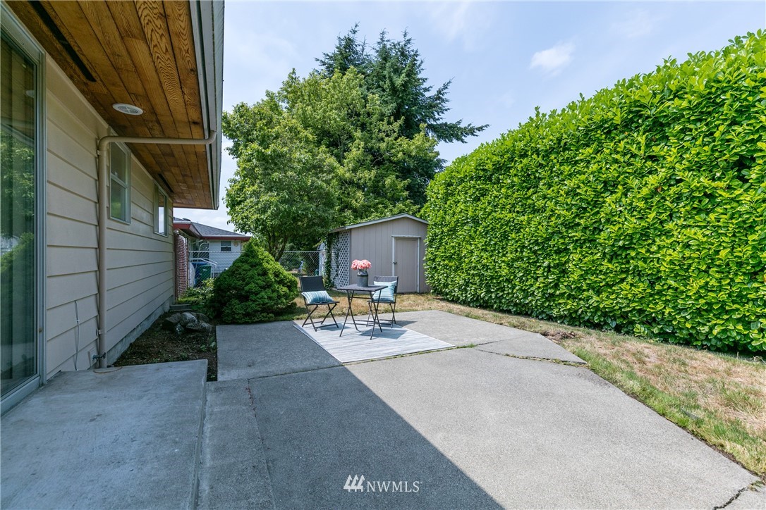 2608 Northeast 18th Street Renton, WA 98056 - Photo 16 of 20 a view of a patio with a table and chairs under an umbrella