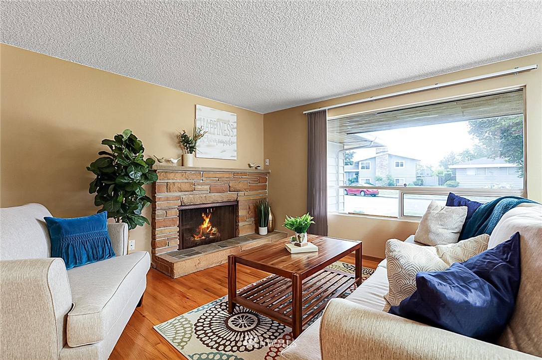 2608 Northeast 18th Street Renton, WA 98056 - Photo 3 of 20 a living room with furniture fireplace and a large window