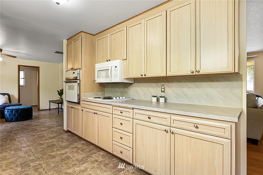 2608 Northeast 18th Street Renton, WA 98056 - Photo 9 of 20 a kitchen with granite countertop white cabinets and sink