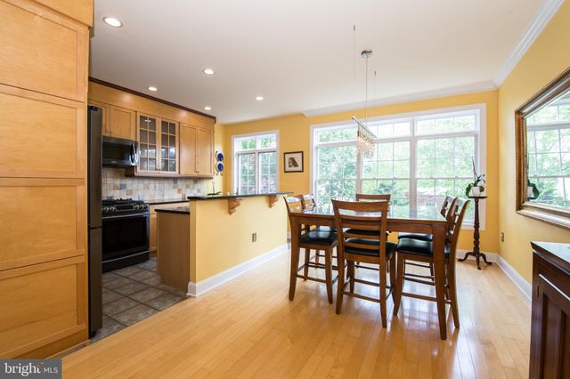 a kitchen with a table chairs sink and cabinets