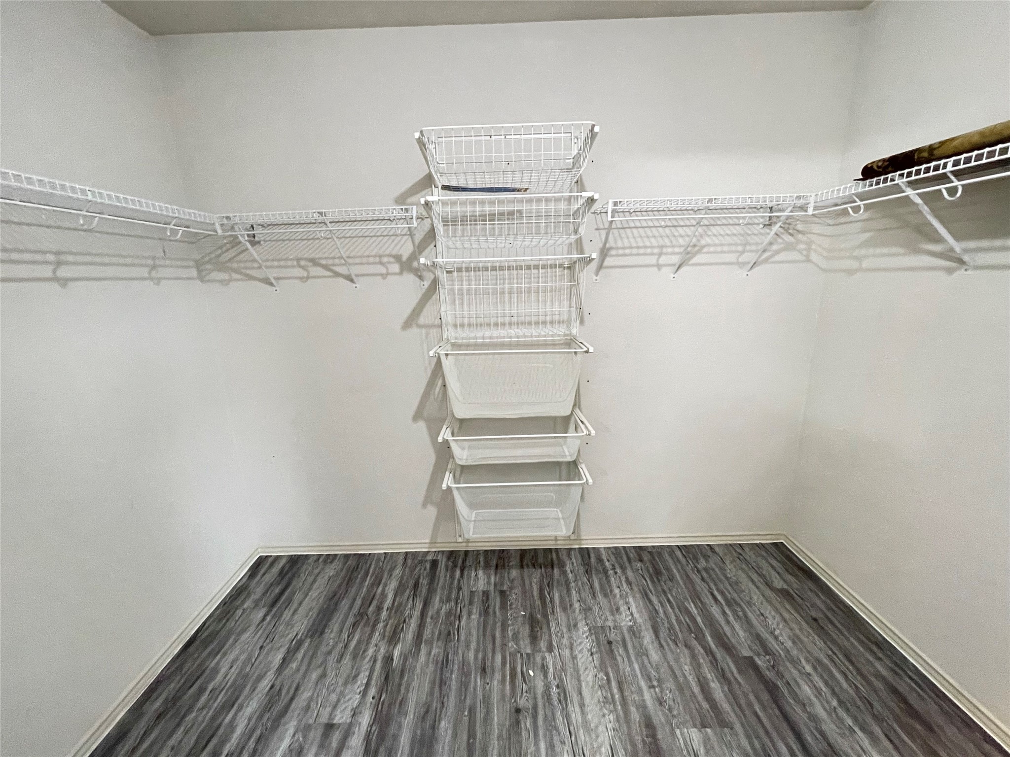 3638 Windhill Loop Round Rock, TX 78681 - Photo 25 of 32 Walk-in closet featuring wire shelving, multiple wire basket drawers, and wood-finish flooring