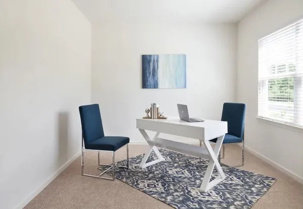 a work room with a couch and a window