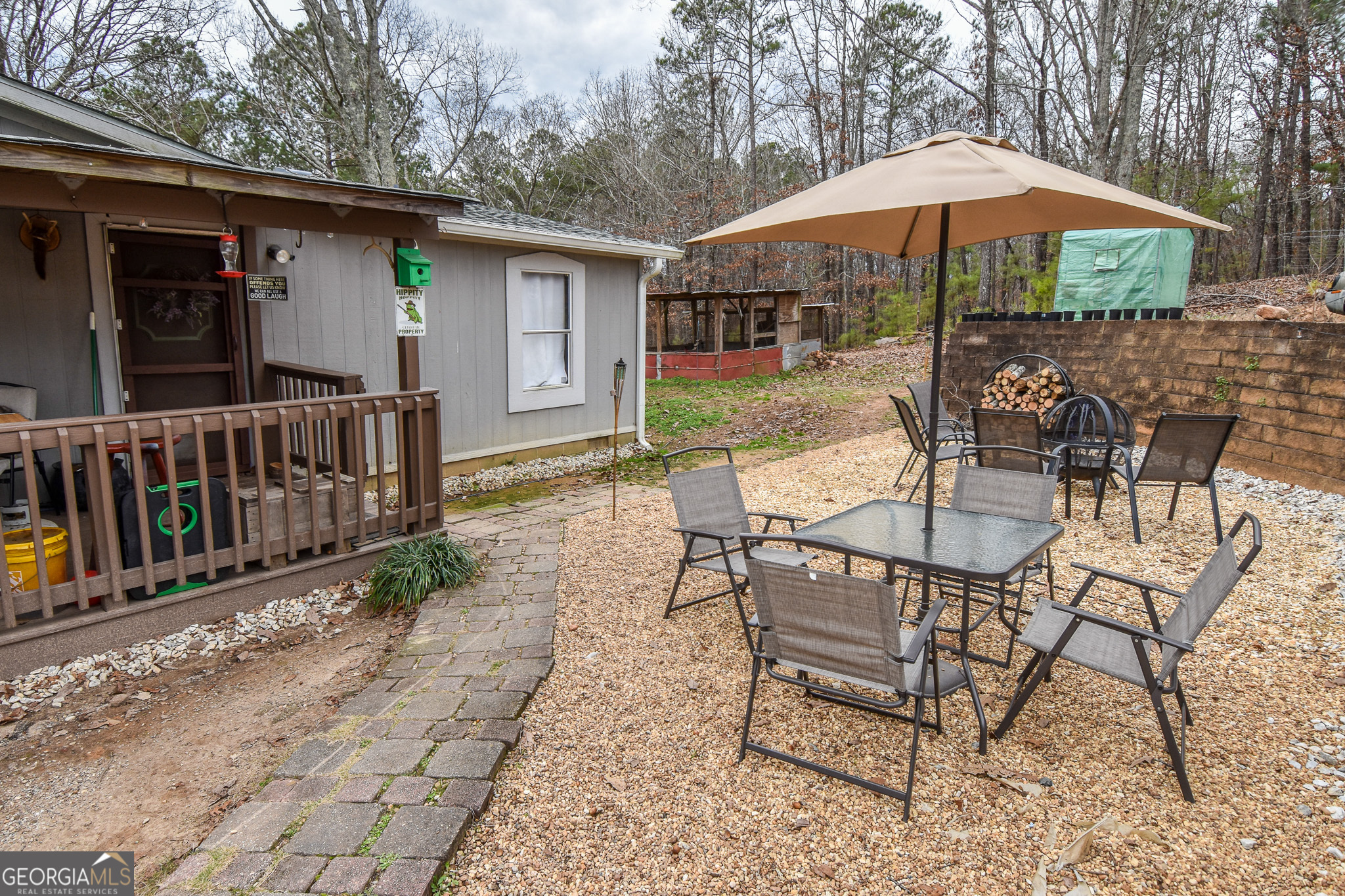 18 Ridgecrest Drive Thomaston, GA 30286 - Photo 11 of 53 a patio with a table and chairs under an umbrella
