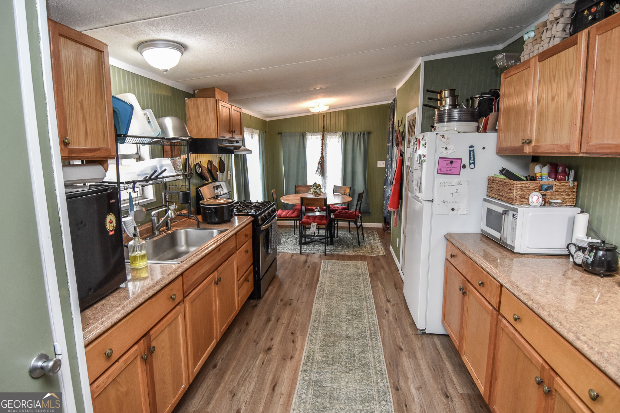 18 Ridgecrest Drive Thomaston, GA 30286 - Photo 28 of 53 a kitchen with kitchen island granite countertop lots of counter top space and wooden floor