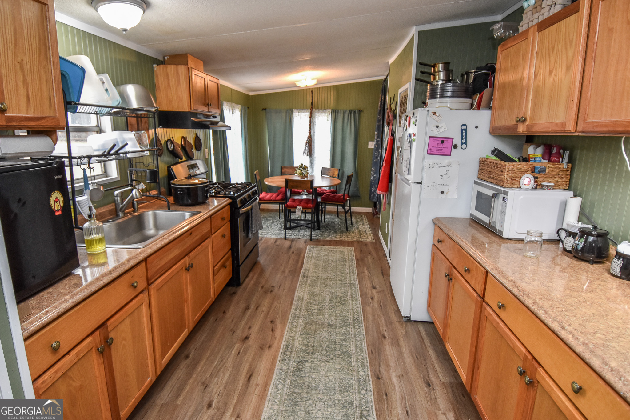 18 Ridgecrest Drive Thomaston, GA 30286 - Photo 32 of 53 a kitchen with kitchen island granite countertop lots of counter top space and wooden floor