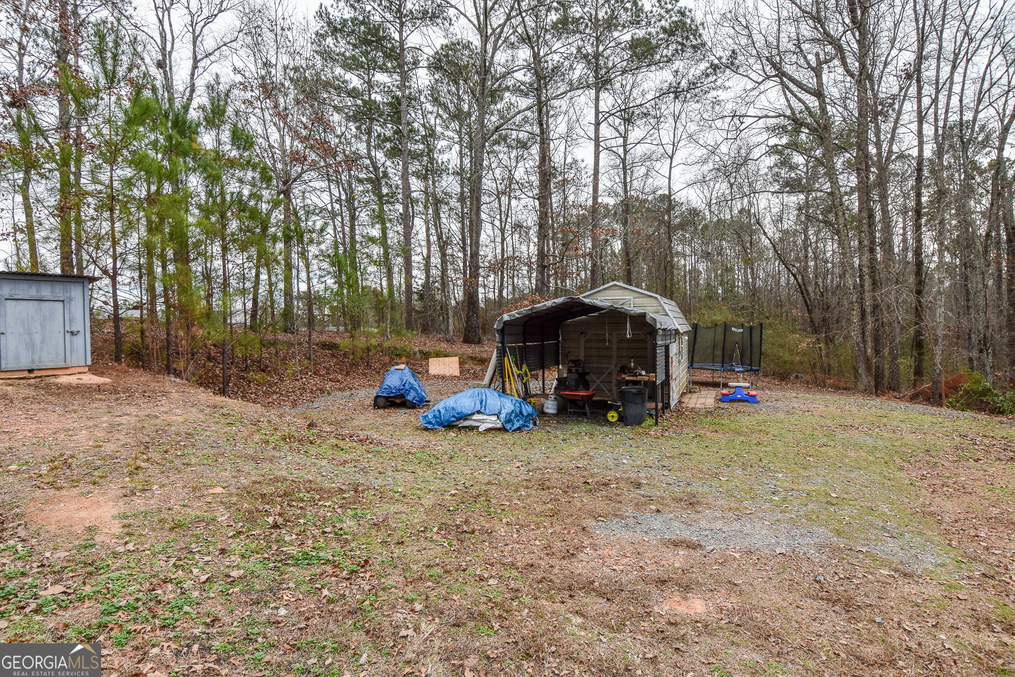 18 Ridgecrest Drive Thomaston, GA 30286 - Photo 7 of 53 a view of a yard with large trees and a barn