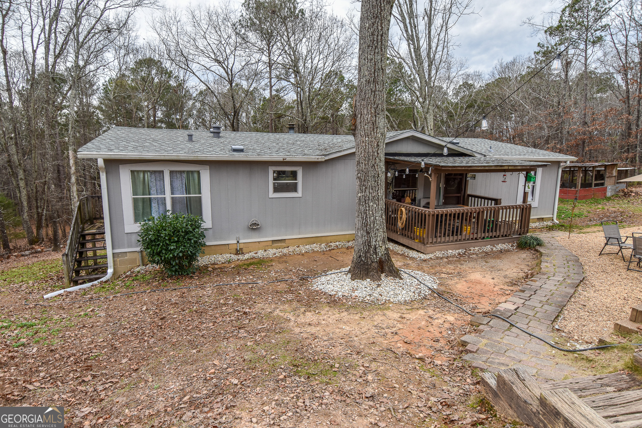 18 Ridgecrest Drive Thomaston, GA 30286 - Photo 10 of 53 a backyard of a house with table and chairs