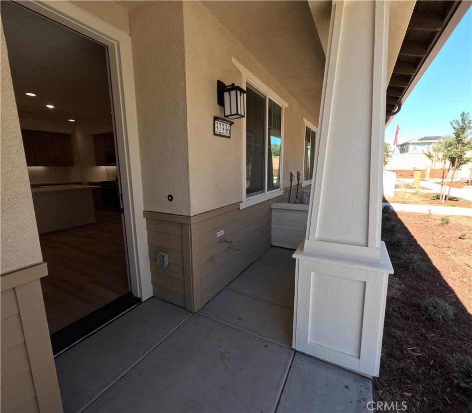 32336 Brunello Way Temecula, CA 92591 - Photo 3 of 25 a view of a hallway with wooden cabinet and stairs