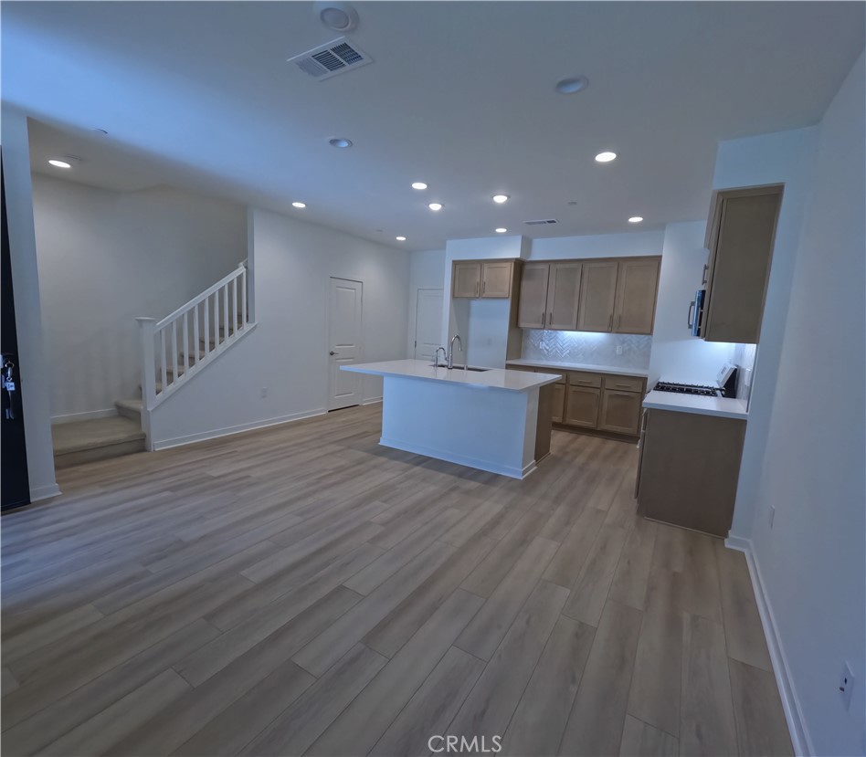 32336 Brunello Way Temecula, CA 92591 - Photo 6 of 25 a view of kitchen living room with wooden floor