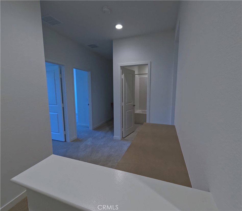 32336 Brunello Way Temecula, CA 92591 - Photo 9 of 25 a view of a hallway with wooden floor