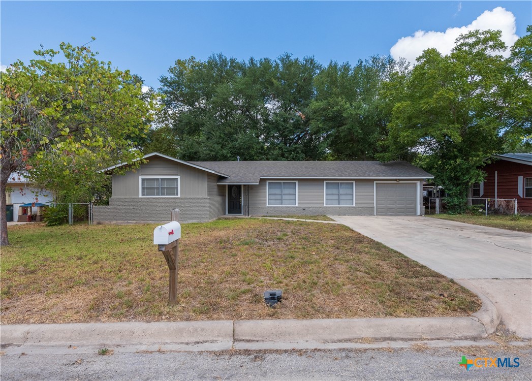 125 Palmo Drive Luling, TX 78648 - Photo 1 of 1 a front view of house with yard and trees in the background