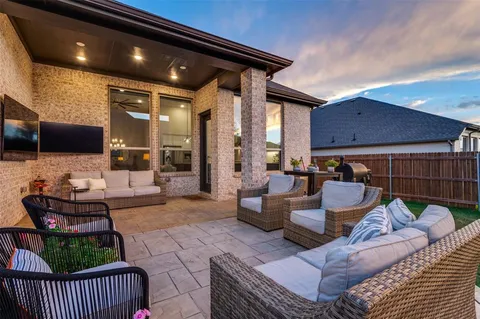 a outdoor living space with patio furniture and a fireplace