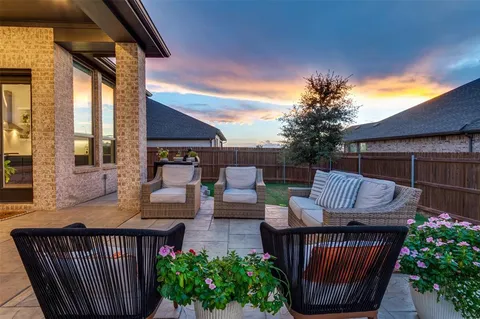 a view of a chair and tables in the patio