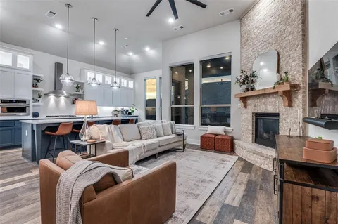 a living room with fireplace furniture and a fireplace
