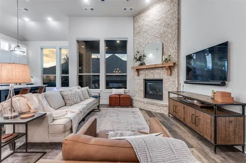 a living room with furniture flat screen tv and a fireplace