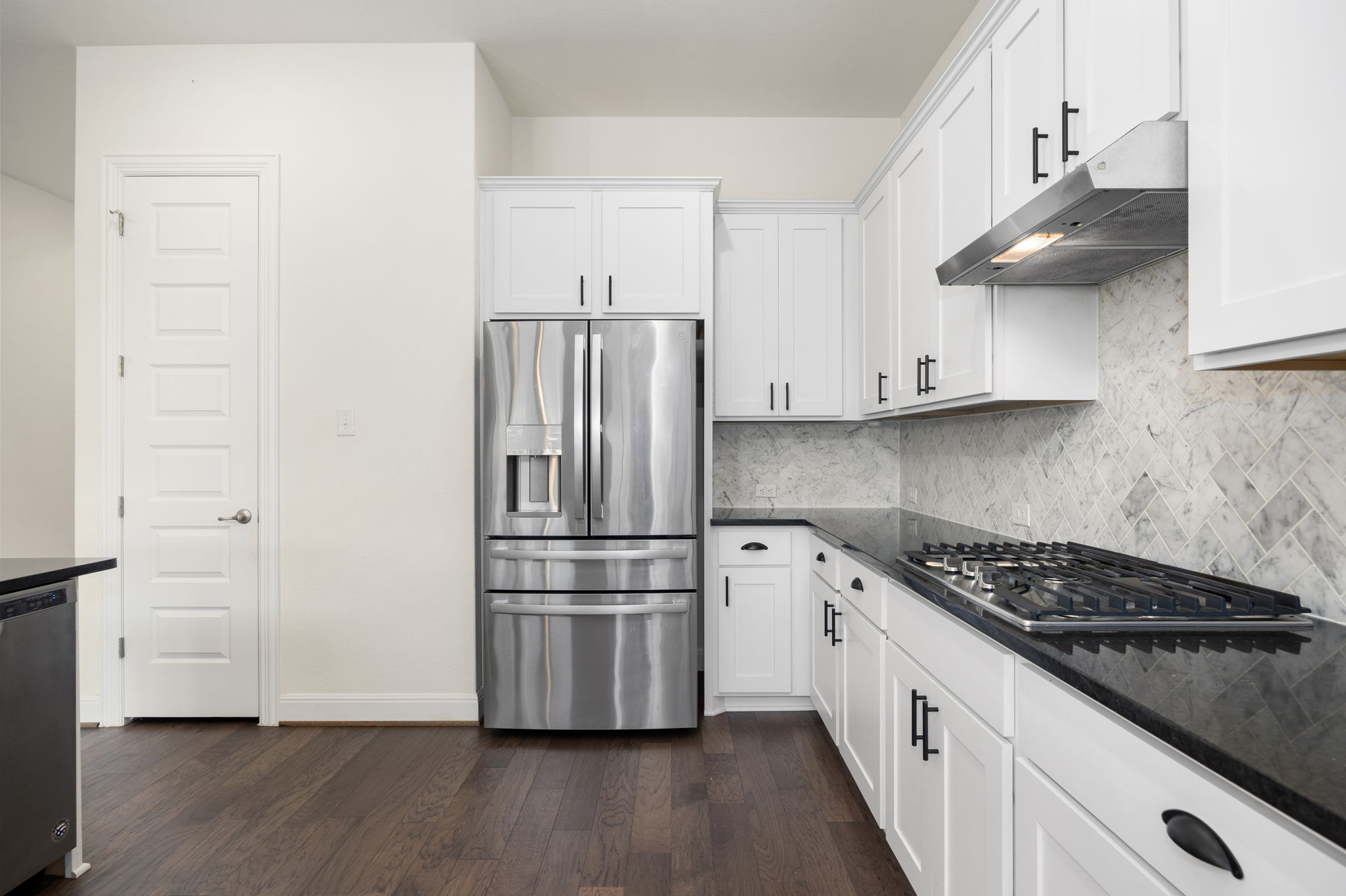 1098 Cherrystone Loop Buda, TX 78610 - Photo 8 of 37 a kitchen with stainless steel appliances and wooden floor