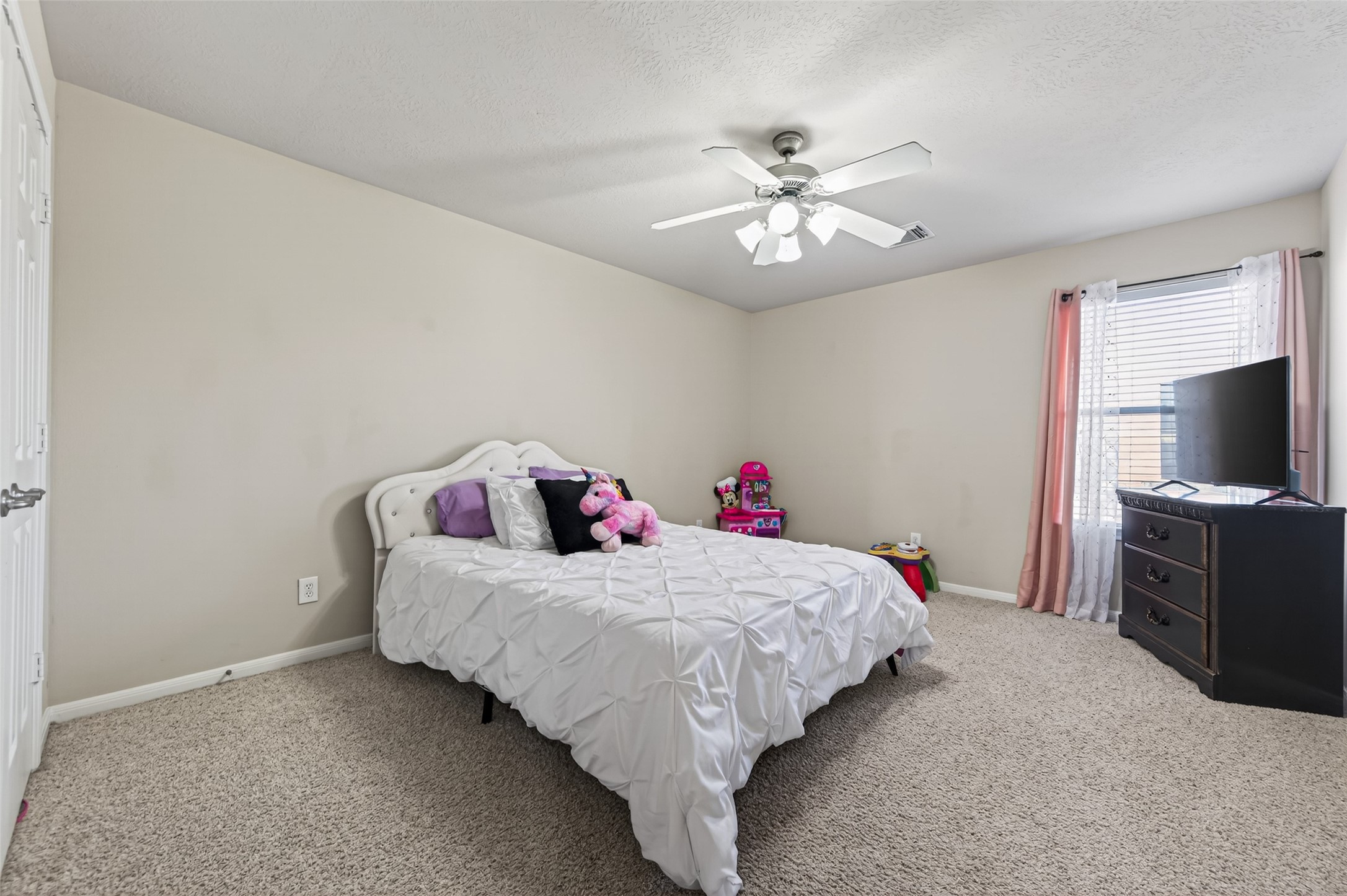 4602 Countrypines Drive Spring, TX 77388 - Photo 15 of 21 a bedroom with a bed and a flat screen tv
