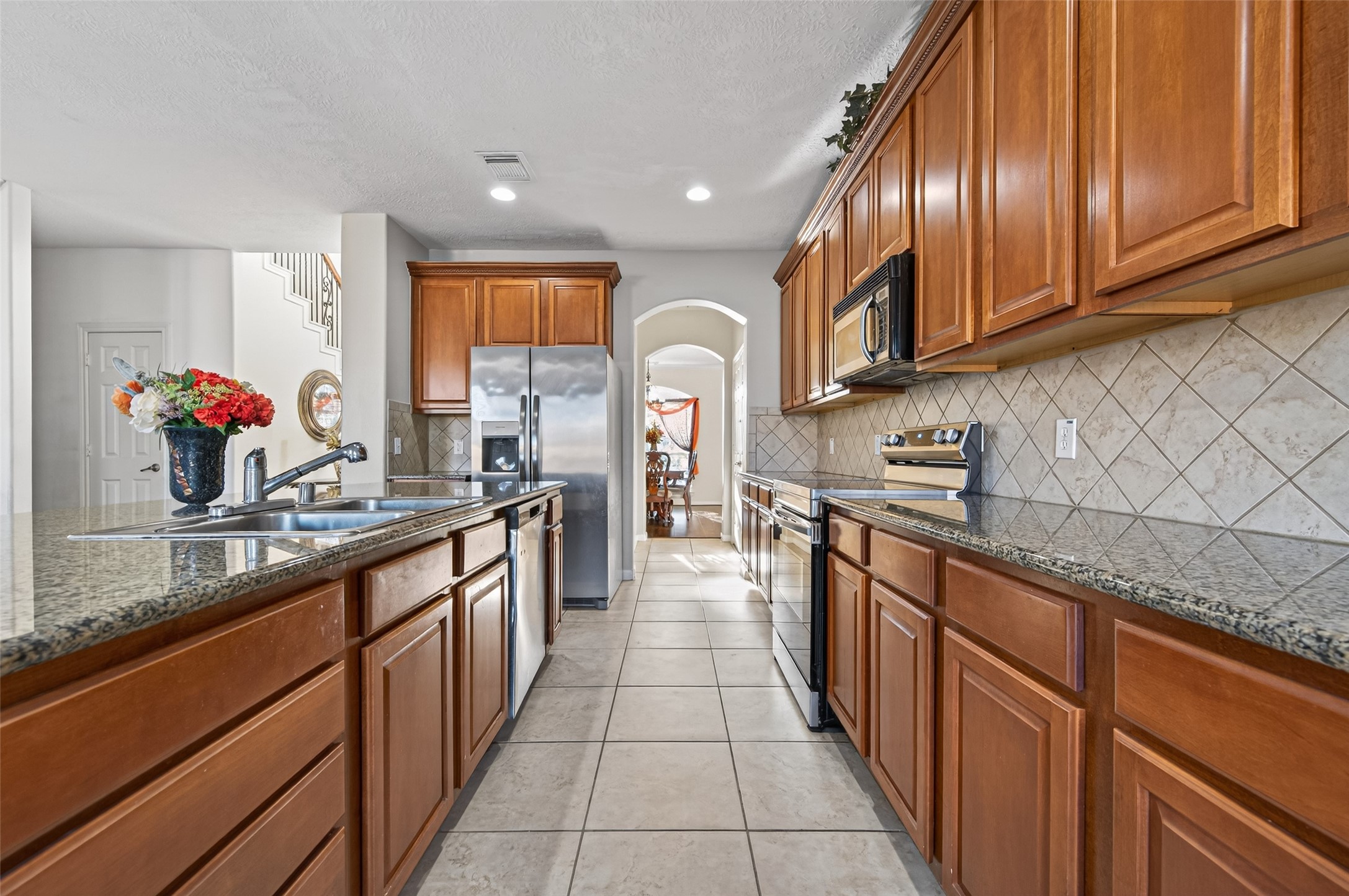 4602 Countrypines Drive Spring, TX 77388 - Photo 5 of 21 a large kitchen with stainless steel appliances granite countertop a sink counter space cabinets and a large window