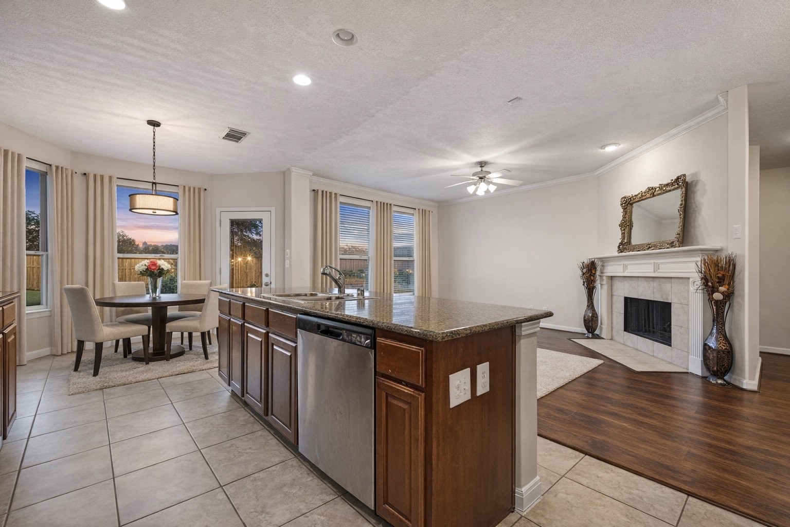 4602 Countrypines Drive Spring, TX 77388 - Photo 6 of 21 a kitchen with stainless steel appliances granite countertop a stove top oven a sink dishwasher a dining table and chairs with wooden floor