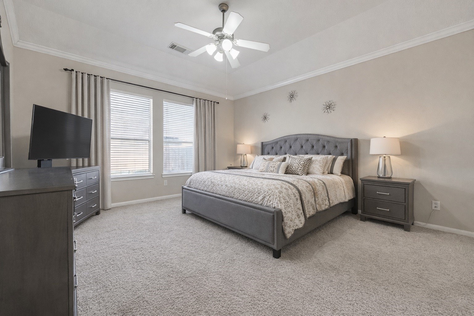 4602 Countrypines Drive Spring, TX 77388 - Photo 9 of 21 a bedroom with a large bed and a flat tv screen on dresser