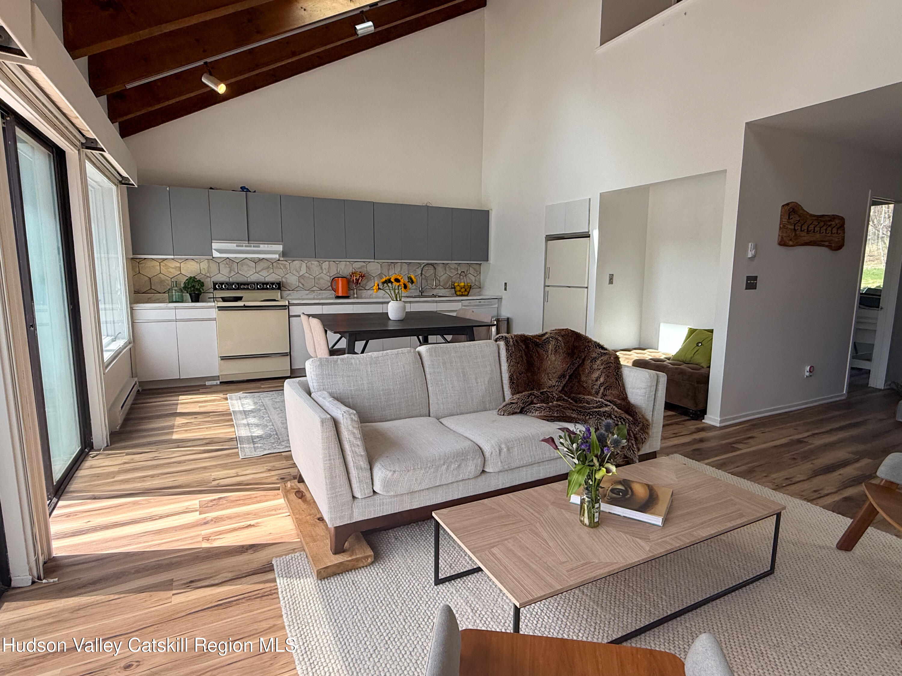 130 Pines Drive, Unit 59 Roxbury, NY 12421 - Photo 13 of 34 a living room with furniture and kitchen view