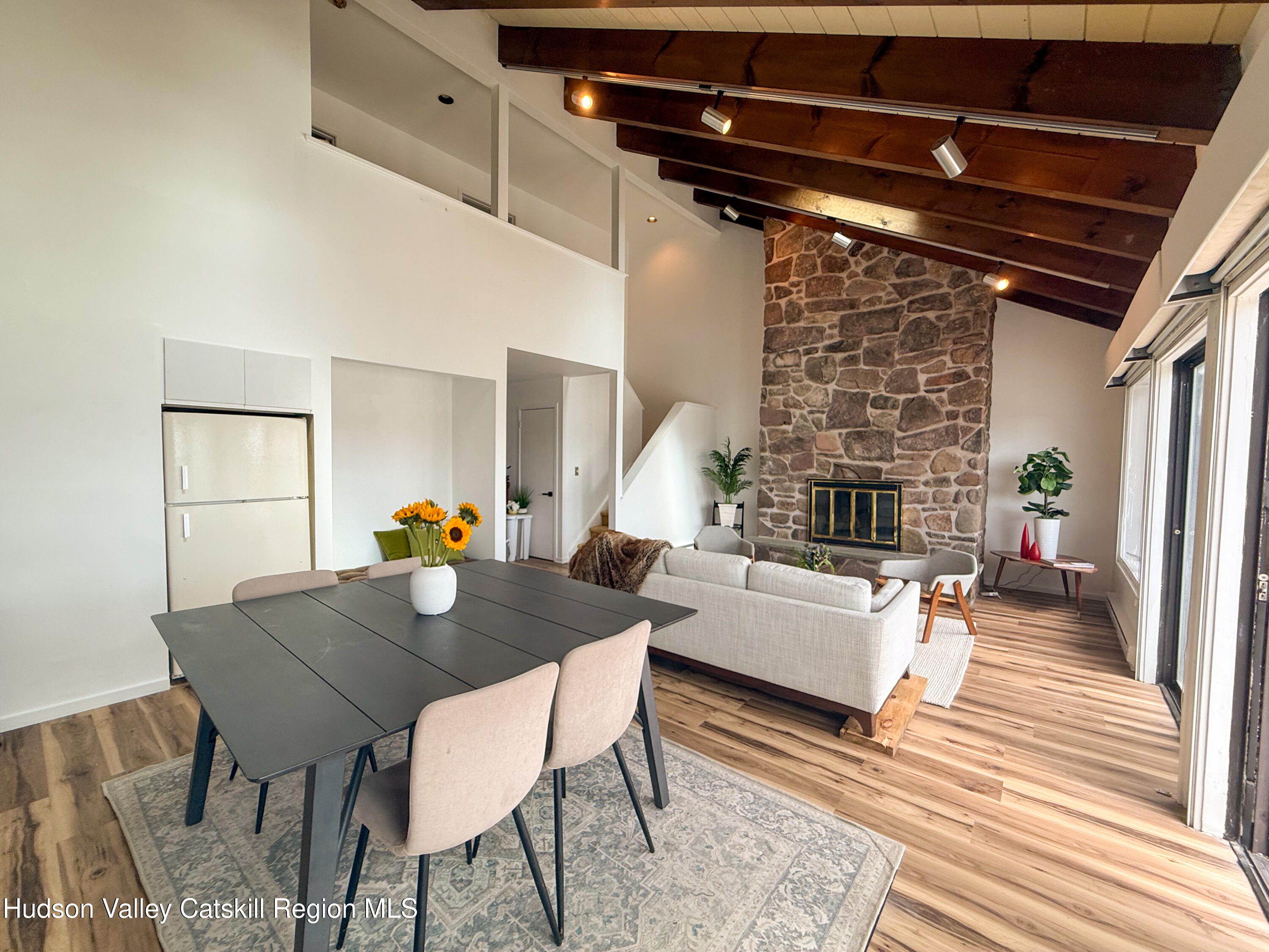 130 Pines Drive, Unit 59 Roxbury, NY 12421 - Photo 14 of 34 a view of a dining room with furniture and wooden floor