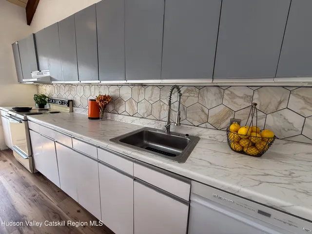 a kitchen with a sink and cabinets
