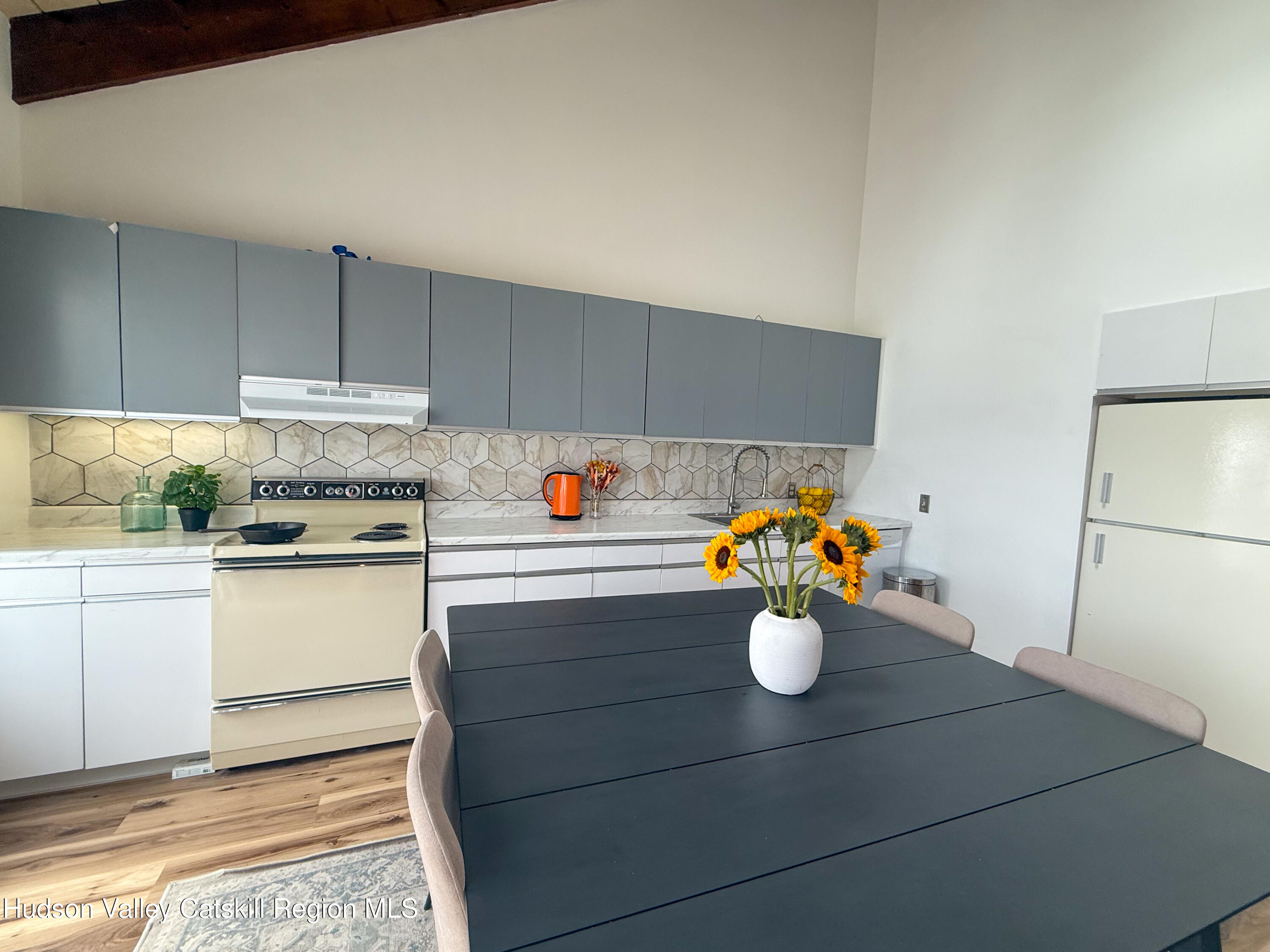 130 Pines Drive, Unit 59 Roxbury, NY 12421 - Photo 16 of 34 a kitchen with a sink and white cabinets