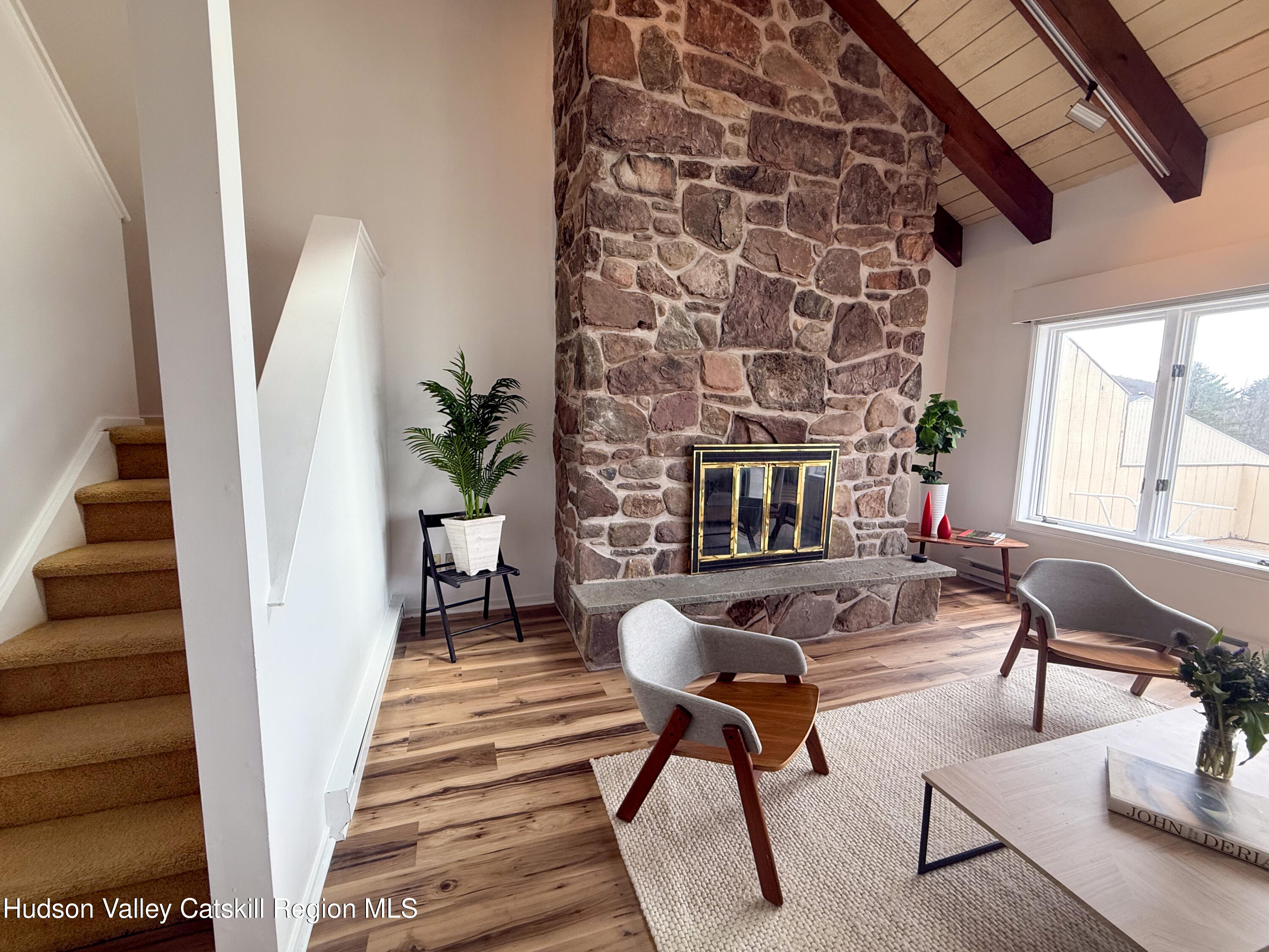 130 Pines Drive, Unit 59 Roxbury, NY 12421 - Photo 17 of 34 a living room with furniture and a fireplace